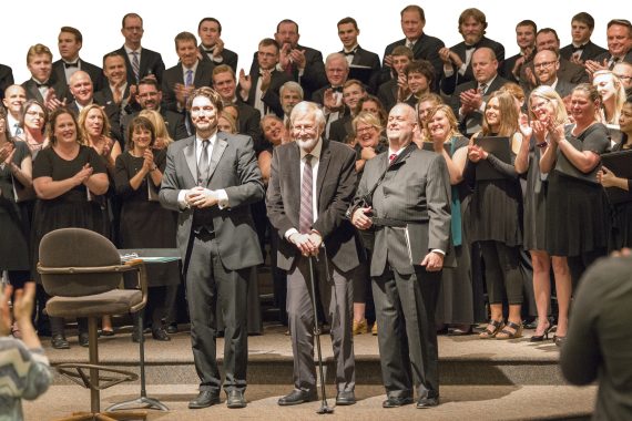 Dr. Dwight Jilek (left) welcomed Dr. Paul Brandvik (center) home to conduct an alumni performance at the Bemidji Choir&rsquo;s 80th anniversary celebration in 2017.