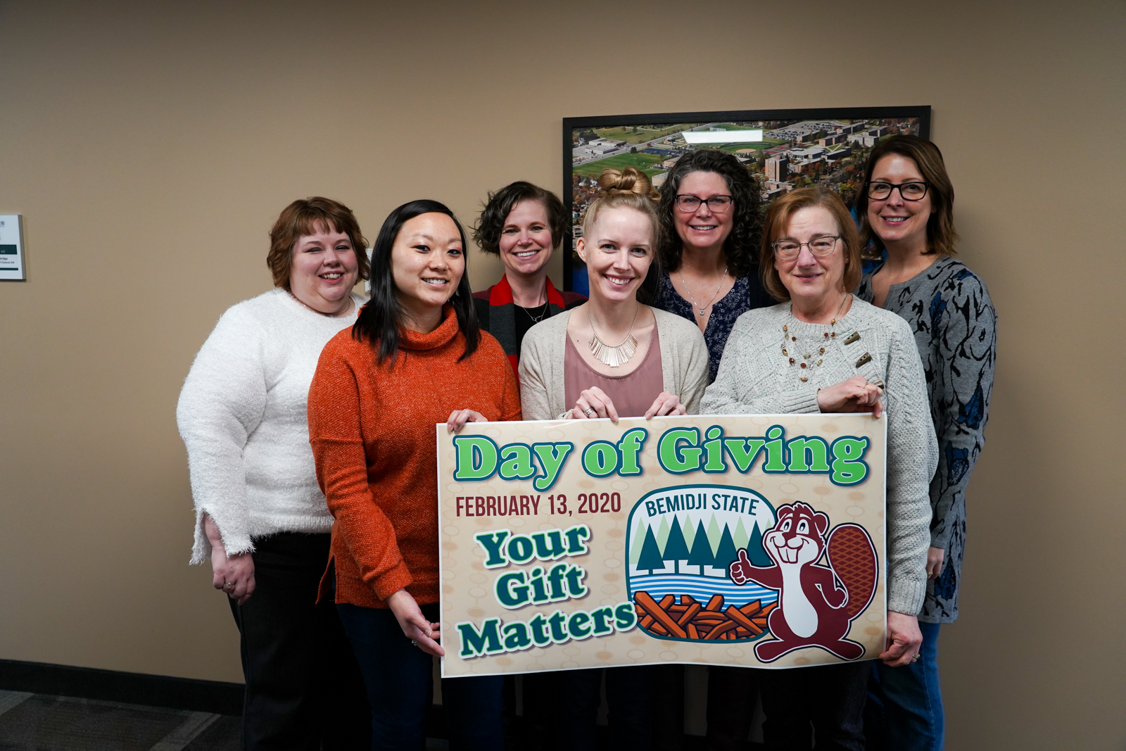 BSU staff with build the dam fundraiser banner