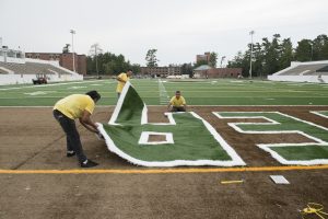 Installing artificial turf at Chet Anderson Stadium.