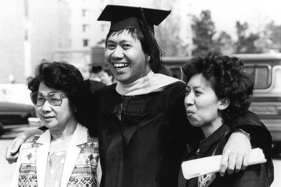A student and his family celebrate graduation, late 1990s.