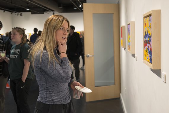 A student enjoys the art of Paul Swenson in BSU&rsquo;s Talley Gallery.