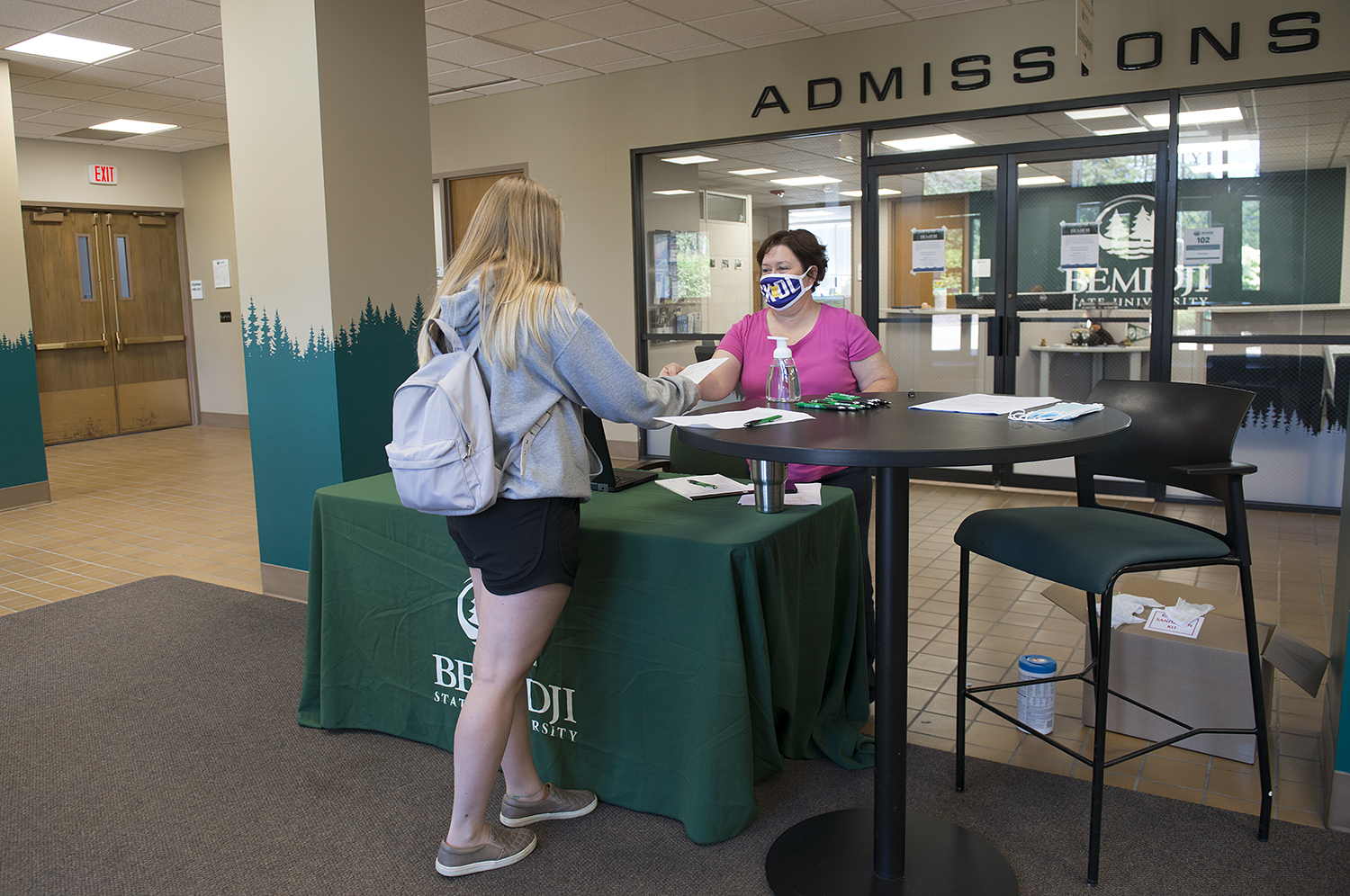 Gina Walkup from the BSU business office staffs the welcome table inside Deputy Hall, to ensure visitors complied with mask-usage guidelines and were completing the required online health screening survey. The station was open during the first few weeks of the Fall 2020 semester.