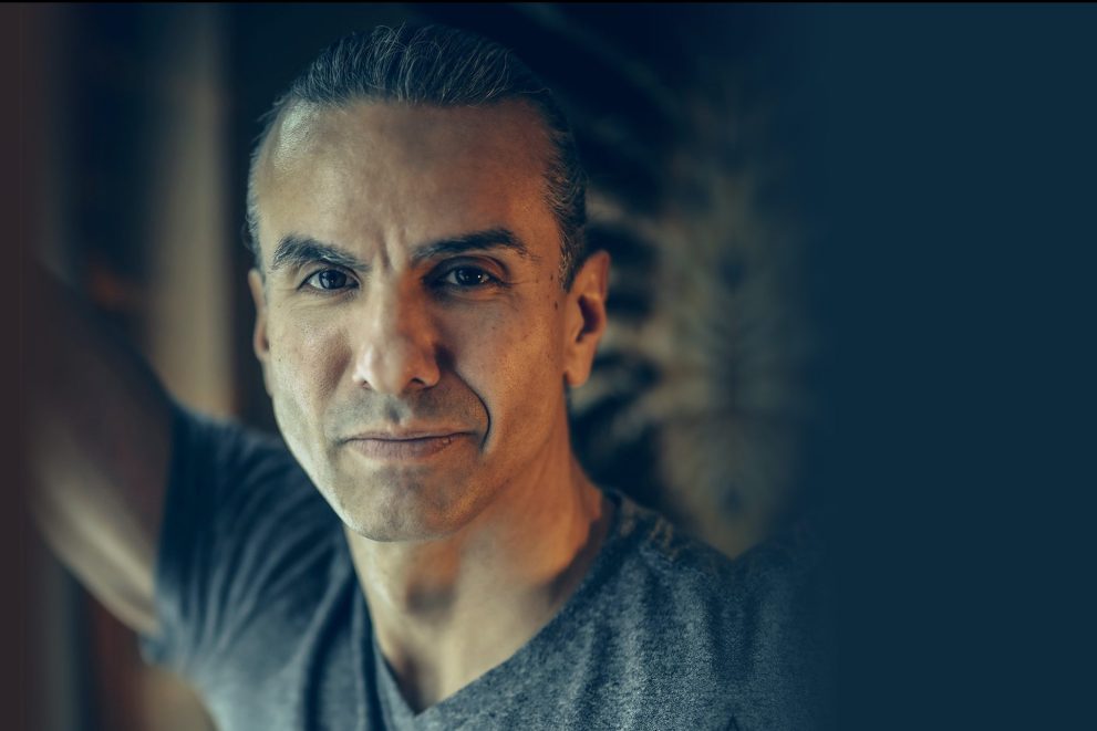 A portrait of Dr. Anton Treuer wearing a grey t-shirt