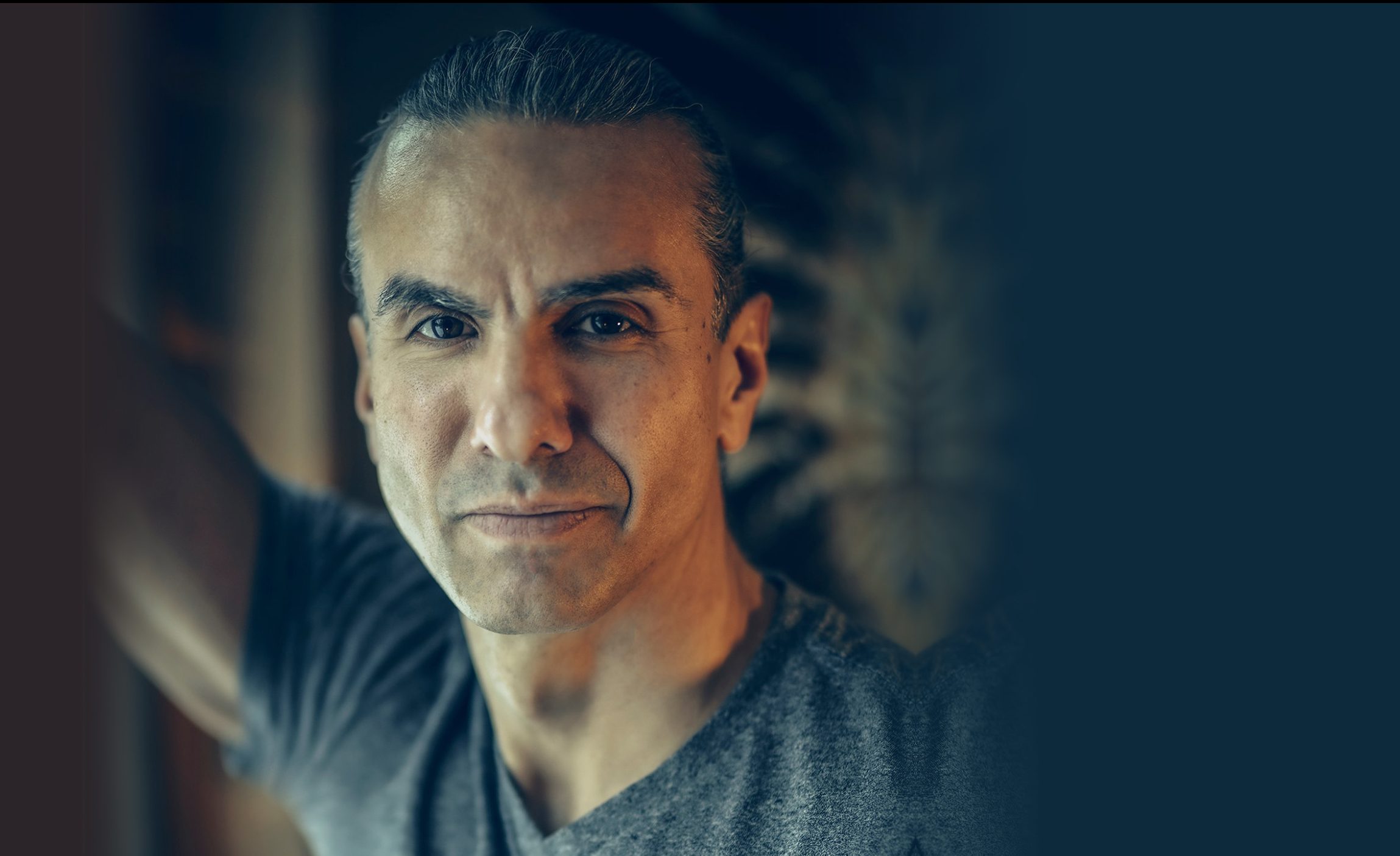 A portrait of Dr. Anton Treuer wearing a grey t-shirt