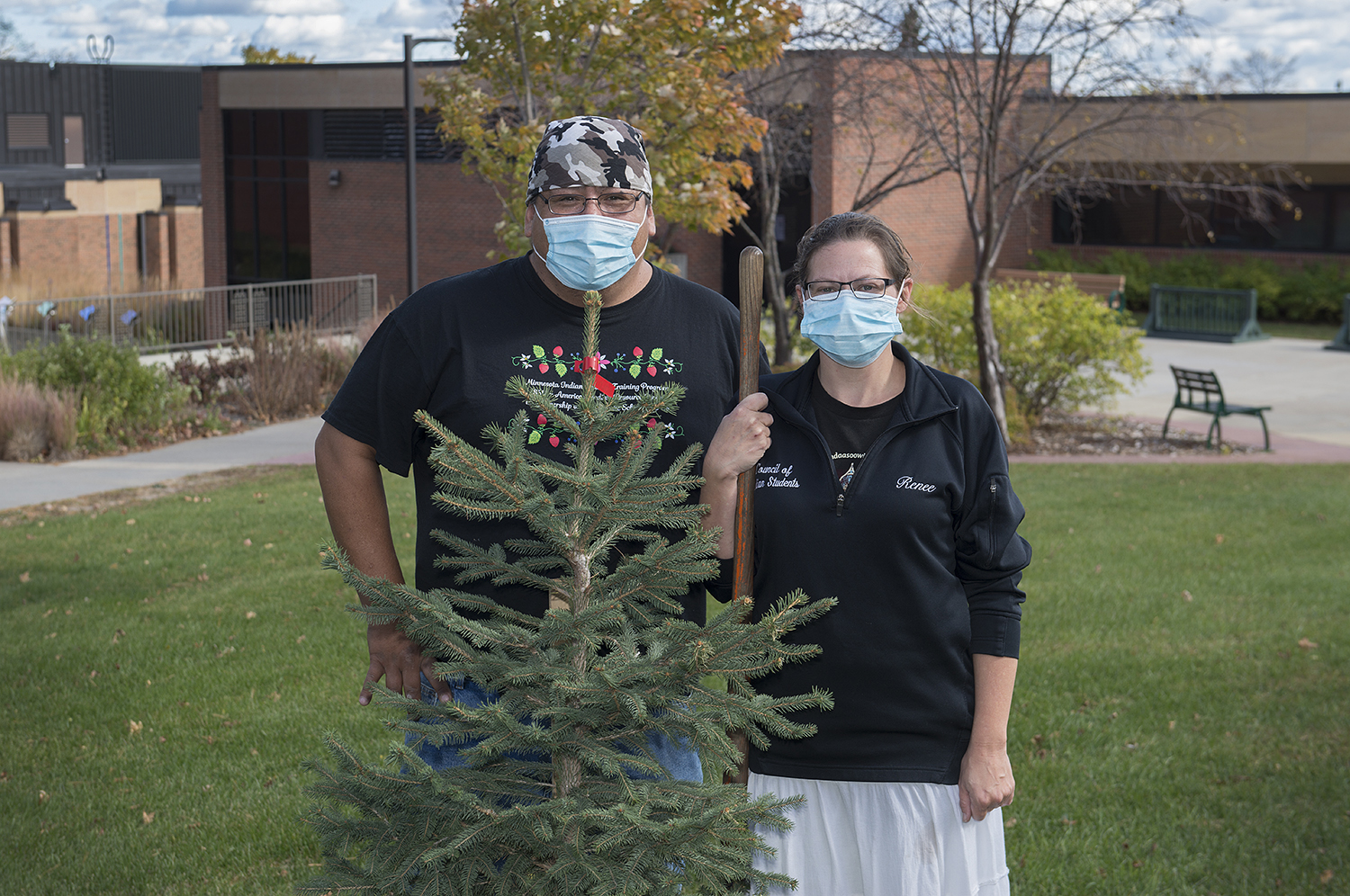 Renee Keezer with her husband, Justin,* *planting a tree on campus as a memorial to the legacy of Raymond and Margaret Carlson and their commitment to the welfare of future generations*.