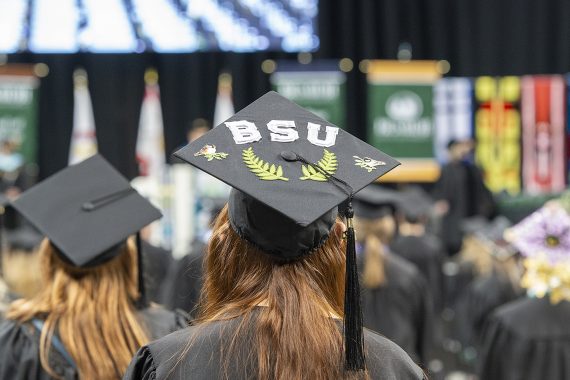 A graduate with a mortar board that says BSU