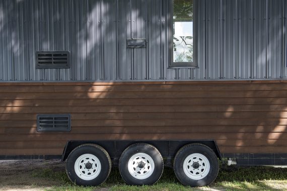 Bemidji State University tiny house Cedar beveled siding and black Pro Panel II Steel Siding.