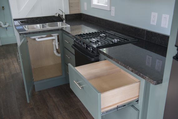 Bemidji State University tiny house Granite countertops, Atwood LP gas range and slide-in cooktop.