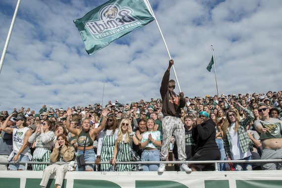 BSU students cheer on the football team in the stands.