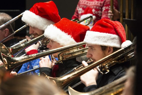 Trombonists performing wearing santa hats at the Bemidji State University Jingle Pops concerts