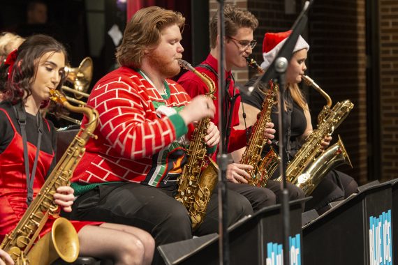 Saxophone players dressed in holiday apparel performing with the Bemidji State Blue Ice Jazz Band