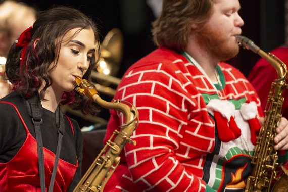 Saxophone players dressed in holiday apparel performing with the Bemidji State Blue Ice Jazz Band