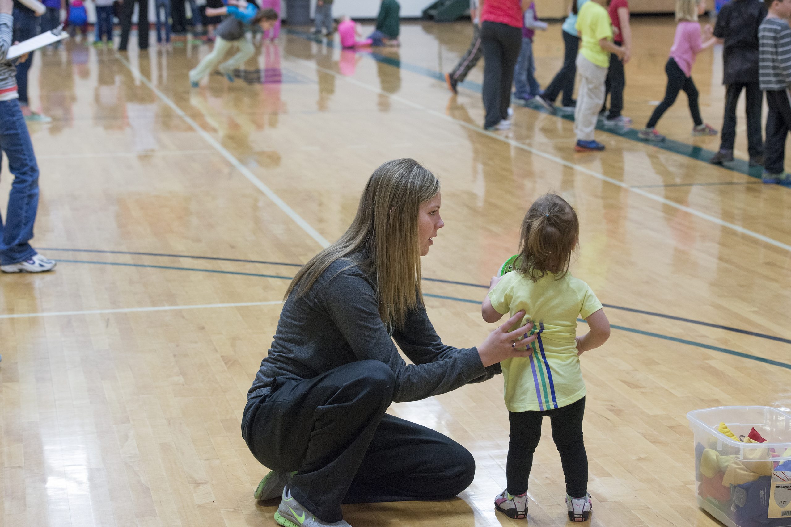 A BSU student helping a young child during Beaver Fitness Day