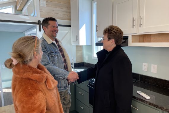 President Faith C. Hensrud shaking Chris Kelly's hand