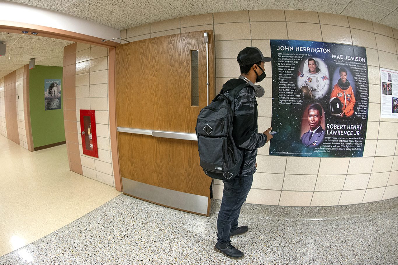 A student readying one of the new Sattgast Halls scientist posters