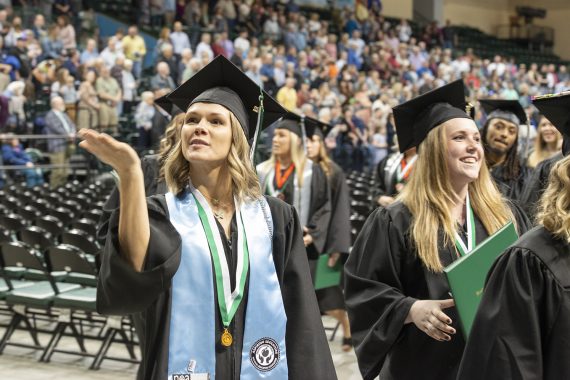 A Bemidji State University graduate blowing a kiss to family in the audience