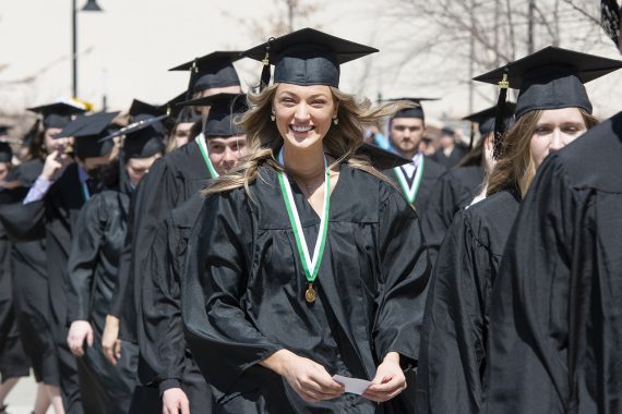 BSU Graduates walking in the Commencement processional outside Bemidji's Sanford Center