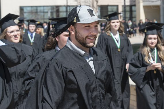 BSU Graduates walking in the Commencement processional outside Bemidji's Sanford Center