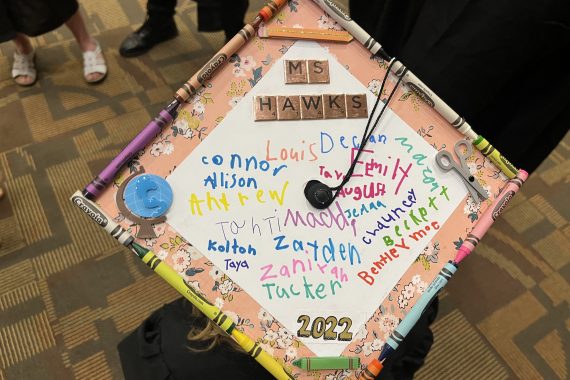 Bemidji State Class of 2022 graduation cap that says "Ms. Hawks" with signatures from local elementary students