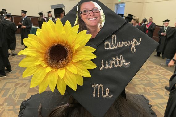 A graduation cap that says "always with me"