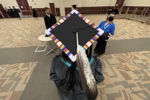 A beaded Bemidji State University Class of 2022 grad cap with an Eagle feather