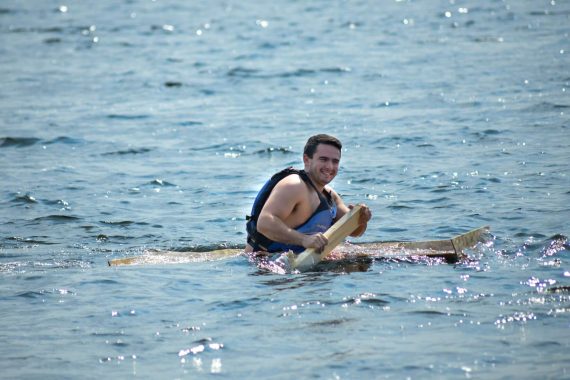 A student paddles their boat on Lake Bemidji