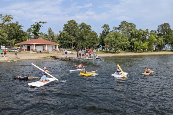 Students paddle their homemade boats on Lake Bemidji.