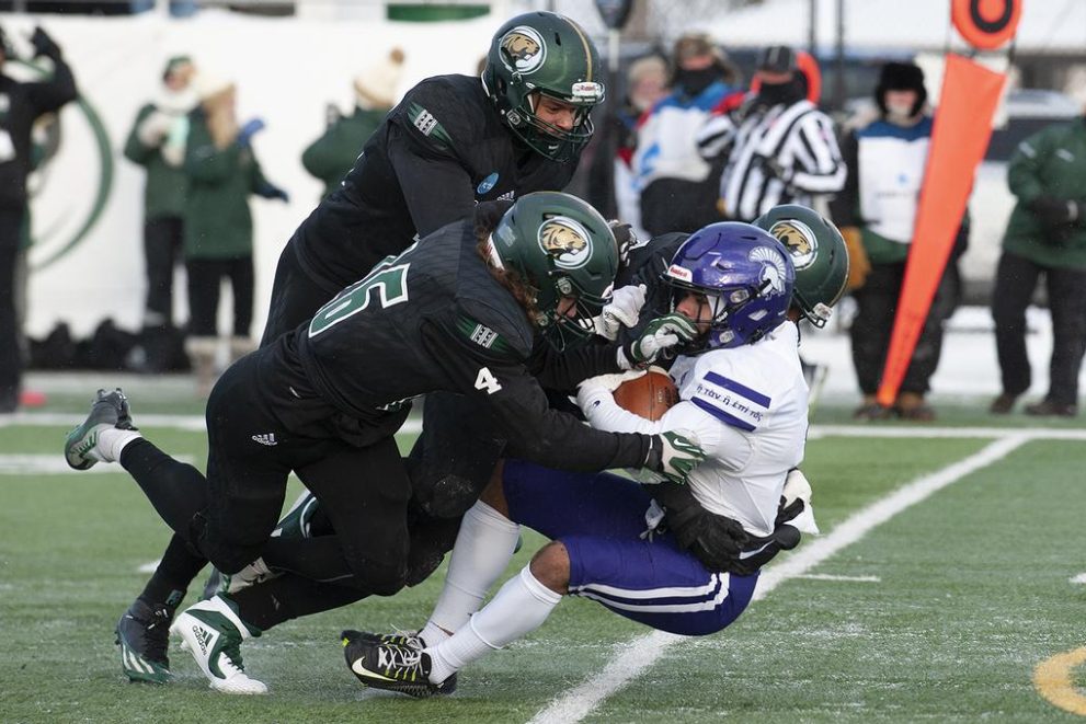 BSU Football players tackle a Winona State player in 2022 playoff game