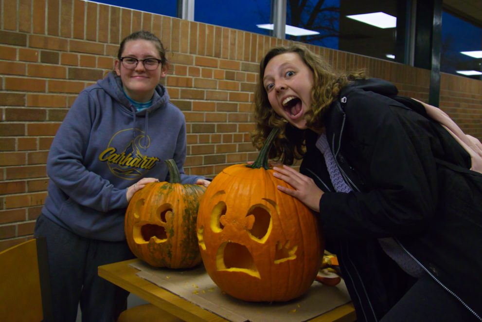 Two students carve pumpkins in Hobson Memorial Union