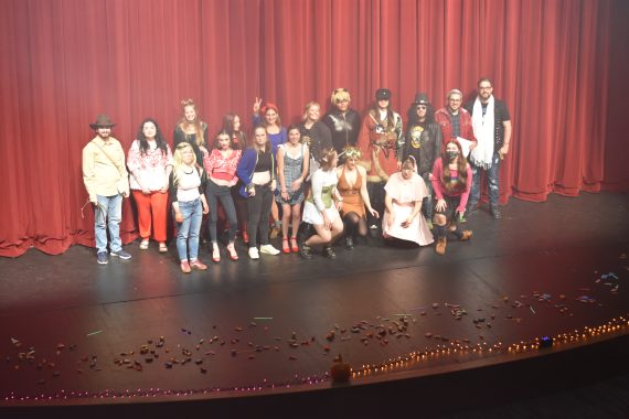 Students in costume on a stage