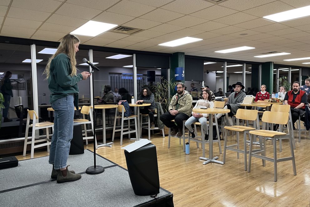 Autumn Miles reading on stage during Milk Tooth 2022 winter reading