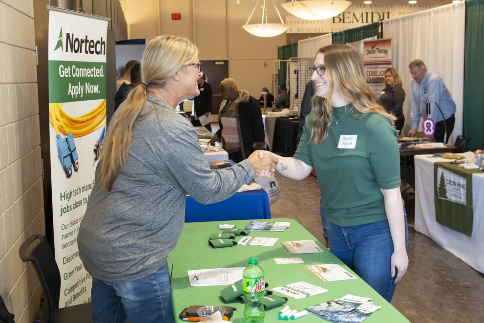 A student interacts with an employer at the career and internship fair at BSU