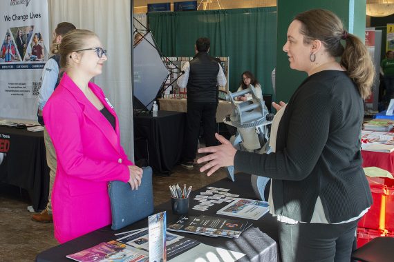 A student interacts with an employer at the career and internship fair at BSU