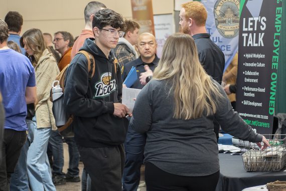 A student interacts with an employer at the career and internship fair at BSU