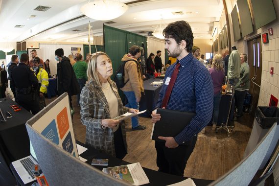 A student interacts with an employer at the career and internship fair at BSU