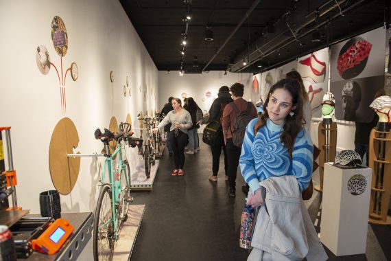 A BSU student looks at the works created by Steve Sundahl as part of the "Down the Rabbit Hole" exhibit in the BSU Talley Gallery