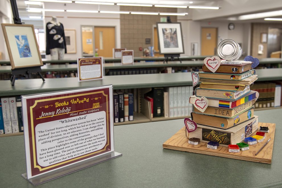 A stack of library book art in the AC Clark Library at Bemidji State for the Books Unbound event