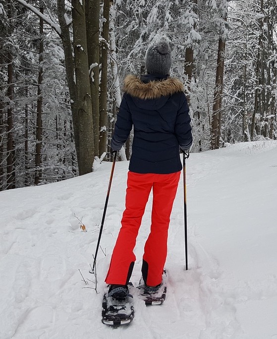 A woman snowshoes in the snow