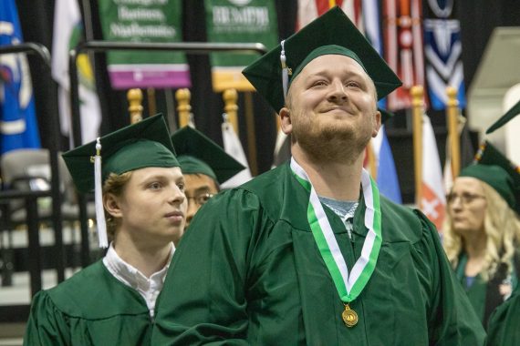 A BSU graduate smiles after receiving their diploma
