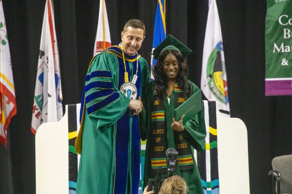 President John Hoffman takes a photo with an African American student