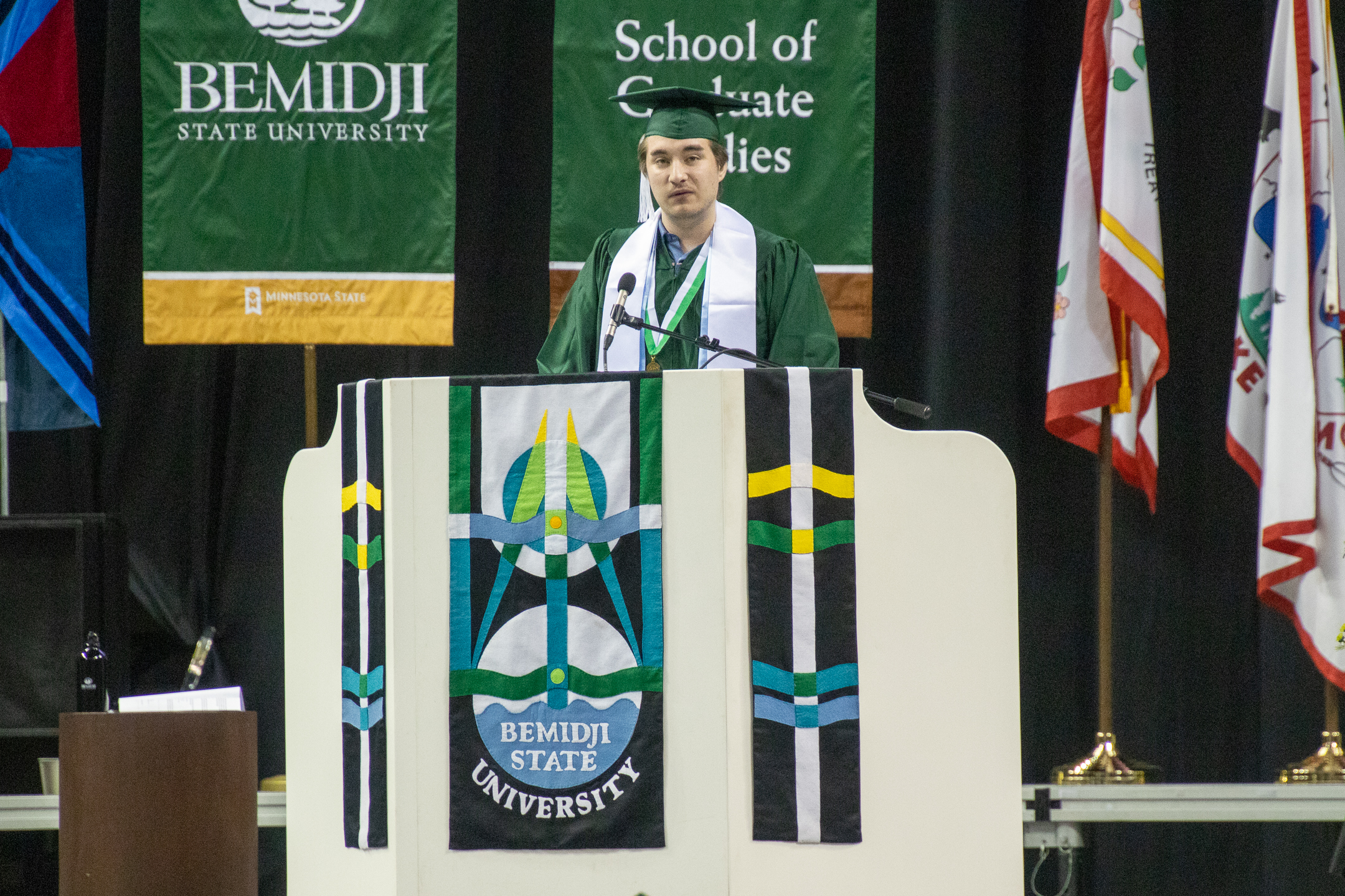 Caleb Travis speaks during commencement