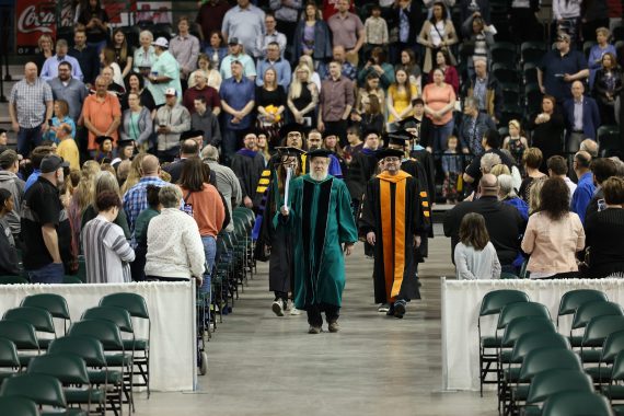 Dr. Mark Fullert leads the processionals of faculty, staff and students into the Sanford Center