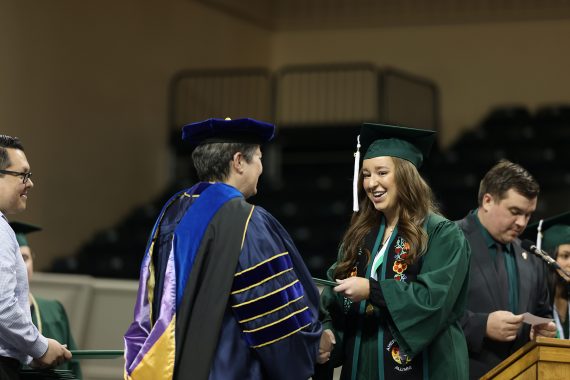 A BSU student takes her diploma