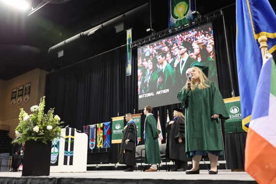 The National Anthem is sung at the BSU commencement ceremony