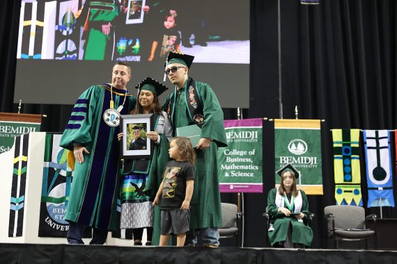 BSU graduates pose for a photo with President John Hoffman