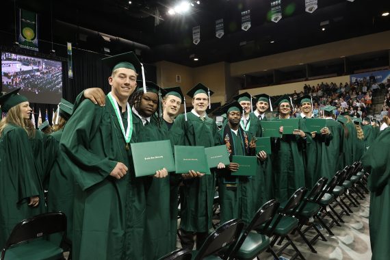 BSU graduates pose with their diplomas