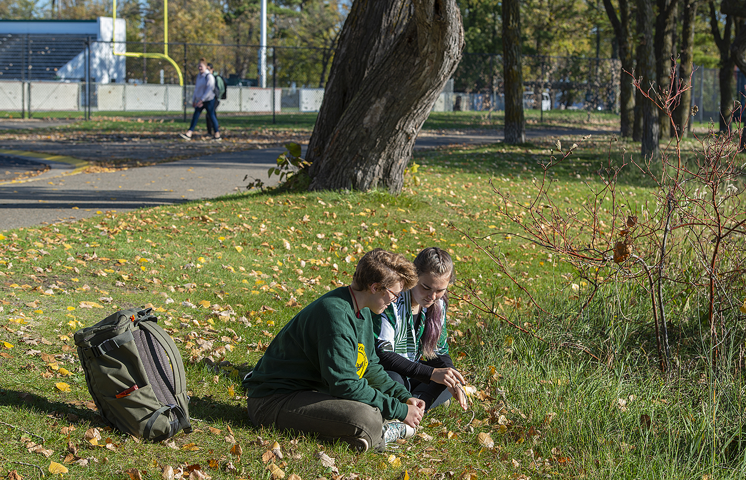 Two Bemidji State students enjoying a fall day by the lake on the Bemidji State campus