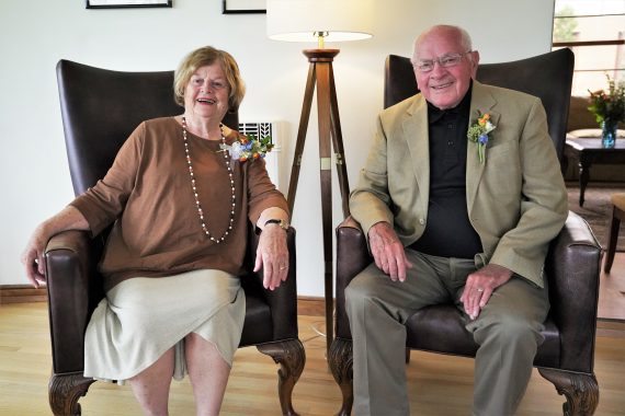 Jim & Nancy Bensen sitting in chairs inside BSU's David Park House.