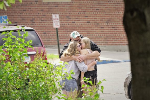 A family hugs during move-in day.