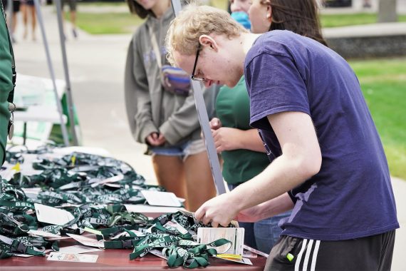 A student searches for their name badge during move-in day.